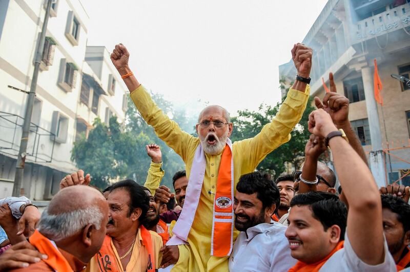 Supporters of the Vishwa Hindu Parishad (VHP) militant organisation celebrate the Indian Supreme Court's verdict on disputed religious site in Ayodhya awarded to Hindus, in Ahmedabad on November 9, 2019. India's top court handed a huge victory to Prime Minister Narendra Modi's Hindu nationalist party on November 9 by awarding Hindus control of a bitterly disputed holy site that has sparked deadly sectarian violence in the past. / AFP / SAM PANTHAKY
