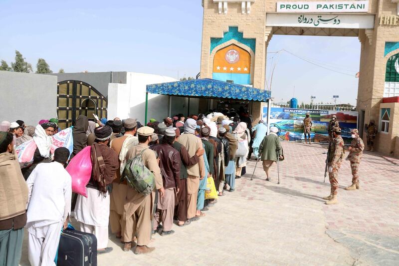 Pakistani security officials stand guard as Afghan arrive to cross the Pakistani-Afghan border in Chaman, Pakistan.  EPA