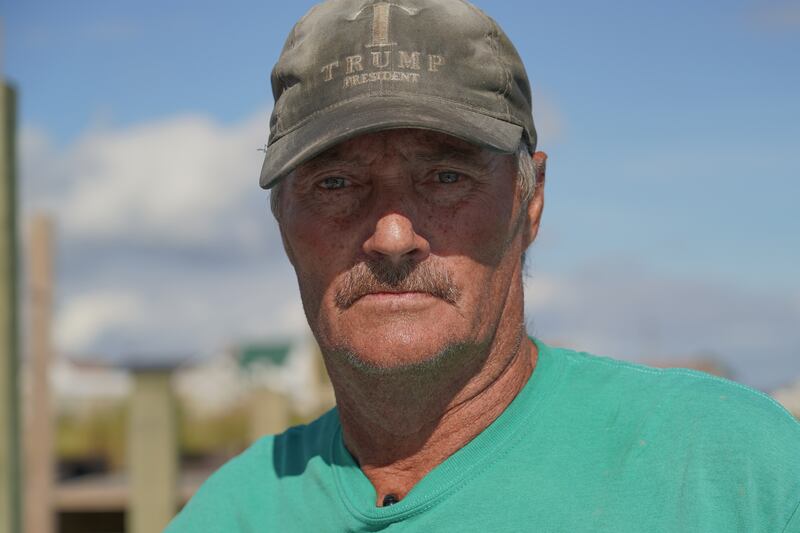 Mr Eskridge dons a Trump hat. The mayor spoke with then-president Donald Trump in 2017 to discuss ways to save the island. 