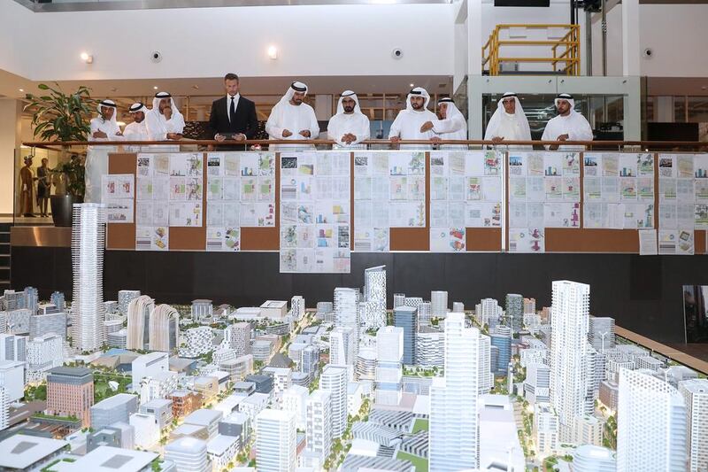Sheikh Mohammed bin Rashid and some senior Dubai Holding officials take a bird's eye view of a scaled down Jumeirah Central project. WAM