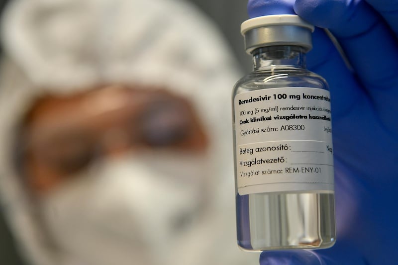 A bottle containing the drug Remdesivir is held by a health worker at the Institute of Infectology of Kenezy Gyula Teaching Hospital of the University of Debrecen in Debrecen, Hungary. A large study led by the World Health Organisation suggests that the antiviral drug did not help Covid-19 patients. Zsolt Czegledi / MTI via AP