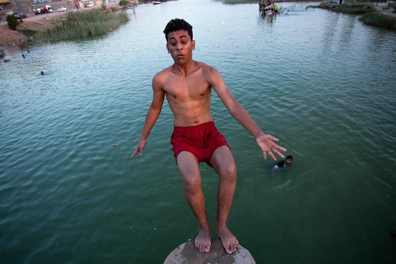 A boy dives in a river near the port in Basra, Iraq.