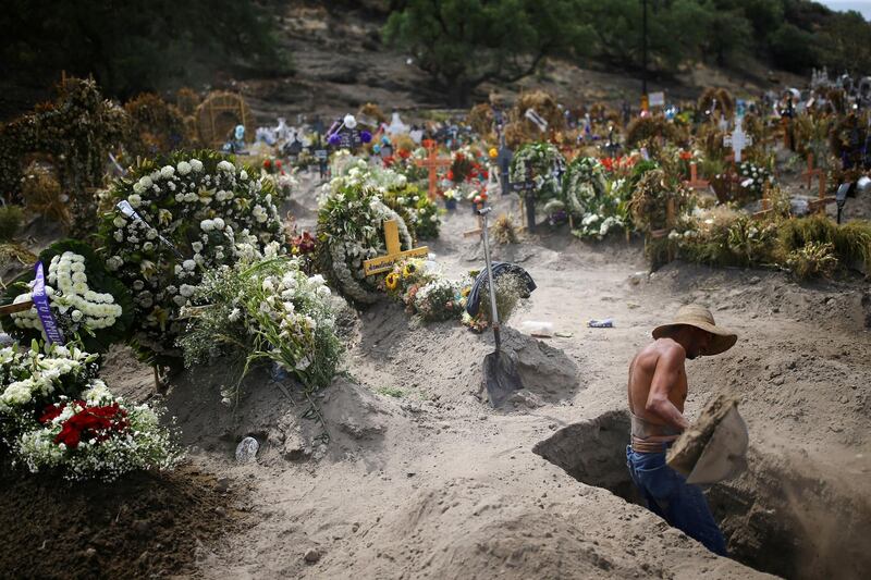 A cemetery worker digs new graves at the Xico cemetery on the outskirts of Mexico City. Reuters