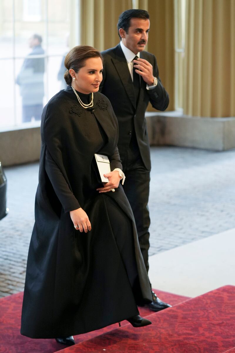 Qatari Emir Sheikh Tamim walks into the reception hosted by Britain's King Charles. AP