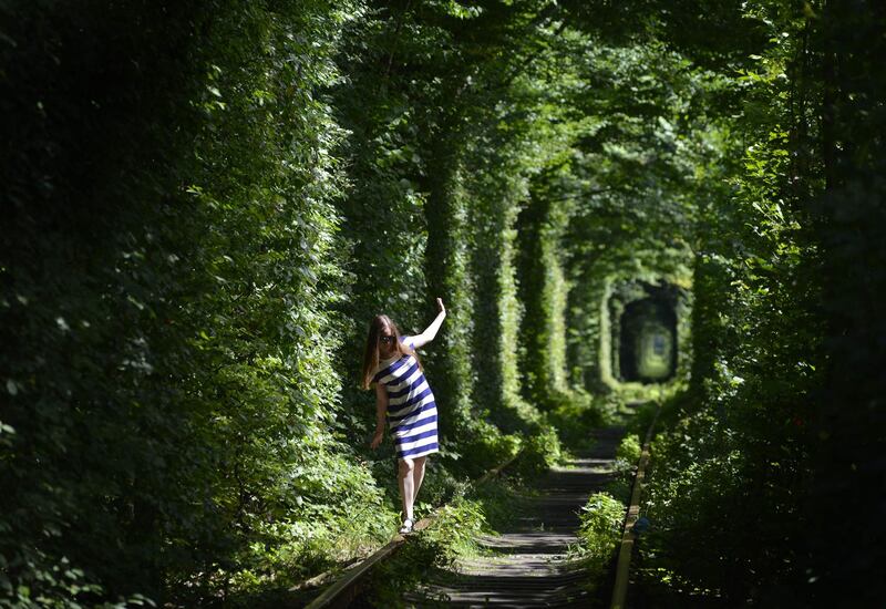 A girl walks along former railway tracks in the so-called Tunnel of Love, surrounded by arches of intertwined trees, near the Ukrainian village of Klevan. Sergei Supinsky/AFP