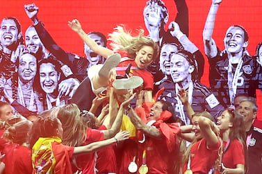 Spain women’s national football team's players lift Spain's defender #19 Olga Carmona (C) as they celebrate on stage their 2023 World Cup victory in Madrid on August 21, 2023.  Spain won the Australia and New Zealand 2023 Women's World Cup final football match after defeating England at Stadium Australia in Sydney on August 20, 2023.  (Photo by Pierre-Philippe MARCOU  /  AFP)