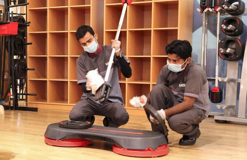 ABU DHABI , UNITED ARAB EMIRATES , March 12 – 2020 :- Cleaning staff sanitising the exercise equipment’s as a preventive measure against coronavirus in the group exercise studio at the Abu Dhabi Country Club in Abu Dhabi.  (Pawan Singh / The National) For News/Online. Story by Haneen