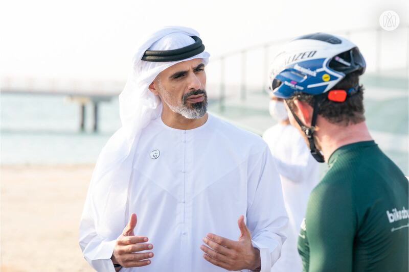 Sheikh Khaled bin Mohamed speaks with a cyclist at the event.