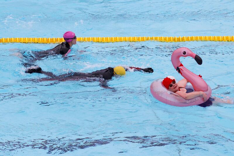 A reveller swims with the aid of an inflatable flamingo at Hillingdon lido in west London as Covid-19 lockdown restrictions ease to allow outdoor sports facilities to open on March 29, 2021. AFP