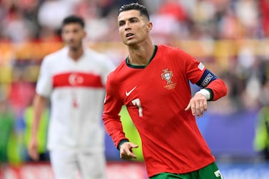 Portugal's forward #07 Cristiano Ronaldo celebrates after setting up the third goal for Portugal's midfielder #08 Bruno Fernandes during the UEFA Euro 2024 Group F football match between Turkey and Portugal at the BVB Stadion in Dortmund on June 22, 2024.  (Photo by INA FASSBENDER  /  AFP)