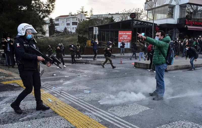 A student confronts a police officer firing rubber bullets during the clashes. AP Photo