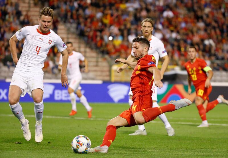 Switzerland's Nico Elvedi, left, and  Belgium's Dries Mertens fight for the ball. EPA