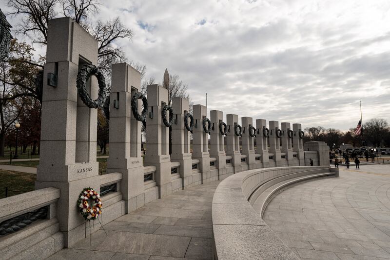 A wreath is set at the base of the Kansas monument at the World War II Monument before the service. EPA