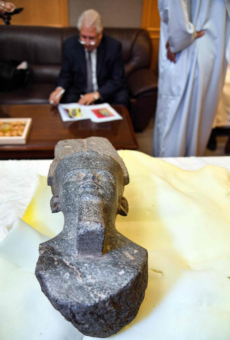 The head of Amun, with the Egyptian ambassador in the background. AFP