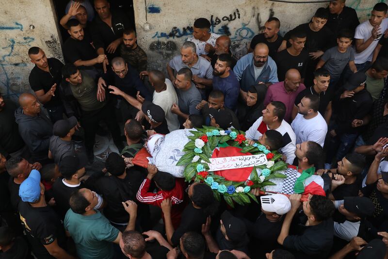Mourners carry the body of Ramzi Zabara during his funeral at Askar refugee camp near the West Bank city of Nablus. October 28, 2022.  The Palestinian Ministry of Health said Zabara, 33, and Imad Abu Rashid, 47, were shot and killed south of Nablus.  EPA