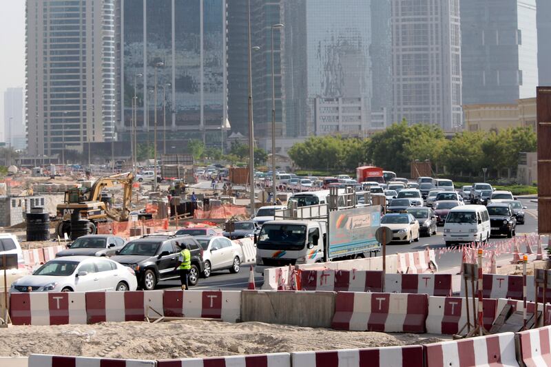Dubai, United Arab Emirates - September 10, 2013.  Traffic building up as early as 8:30 am in this small temporary roundabout at the back of the JLT towers but slowly improving due to securities or traffic enforcers around the area.  ( Jeffrey E Biteng / The National )  Editor's Note;  Caline M reports. *** Local Caption ***  JB100913-Traffic01.jpg