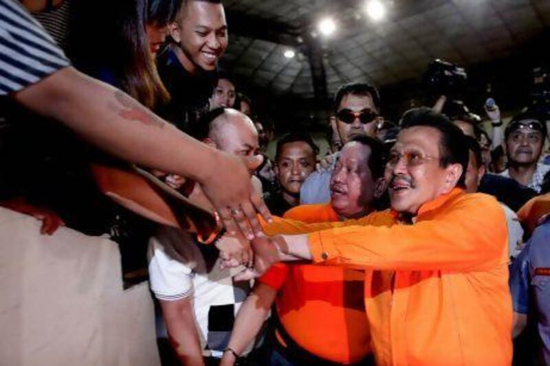 Former Philippines president Joseph Estrada is congratulated by supporters after being proclaimed as the new mayor of Manila.