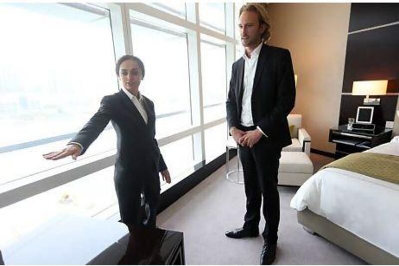 "For us, all guests are VIPs," says the Rosewood Abu Dhabi butler Nona Zazikashvili, here helping hotel guest Frederic Robert. Sammy Dallal / The National
