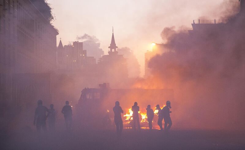 Protesters move through a cloud of tear gas during a protest at Martyrs Square. Getty Images