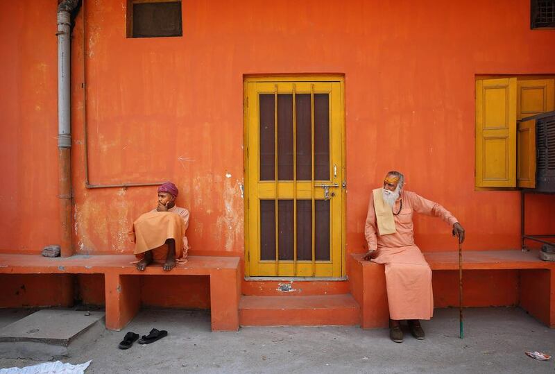 Two Indian Hindu holy men wait for others to join them before they leave to cast their votes during the eighth phase of voting of the Indian parliamentary elections in Haridwar, India. Manish Swarup / AP