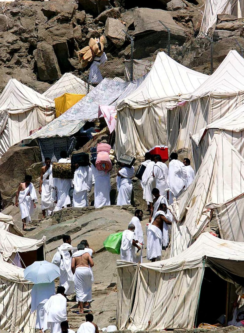Pilgrims carry their belongings to their tents in Mina in March 1999. Hundreds of thousands of Muslims spent the night at the tent city before end of the pilgrimage. AFP