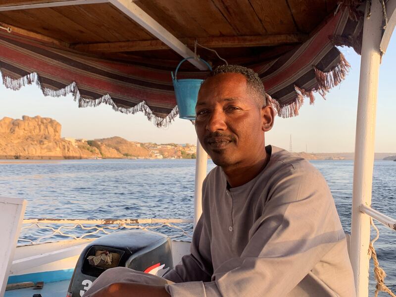 Hamza Abdel Rasool, 41, a native of Nubia in southern Egypt, makes his living ferrying people across the Nile. Hamza Hendawi for The National