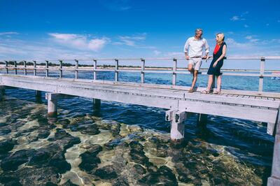 Couple on the boardwalk near the Stromatolites at Hamelin Pool Marine Nature Reserve in the Shark Bay World Heritage Area. 