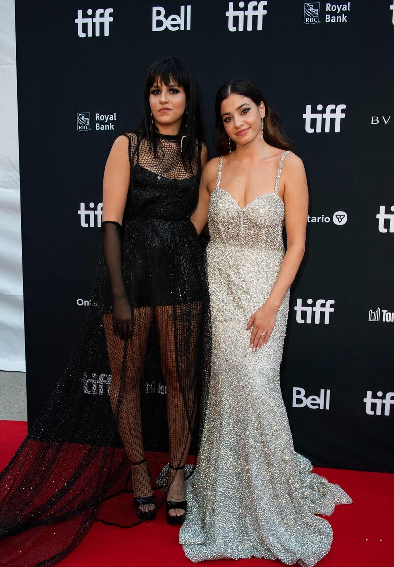 Syrian sisters Sarah Mardini, left, and Yusra Mardini arrive for 'The Swimmers' premiere at Roy Thomson Hall. AFP