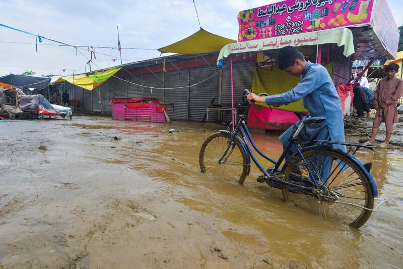 A villager pushes a bicycle along a road in Charikar, Parwan province.  AFP