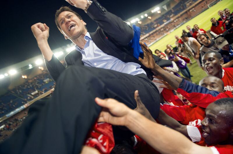 Lille coach Rudi Garcia celebrates with players at the final whistle of the French L1 football match against Paris Saint-Germain as Lille are crowned French champions. AFP