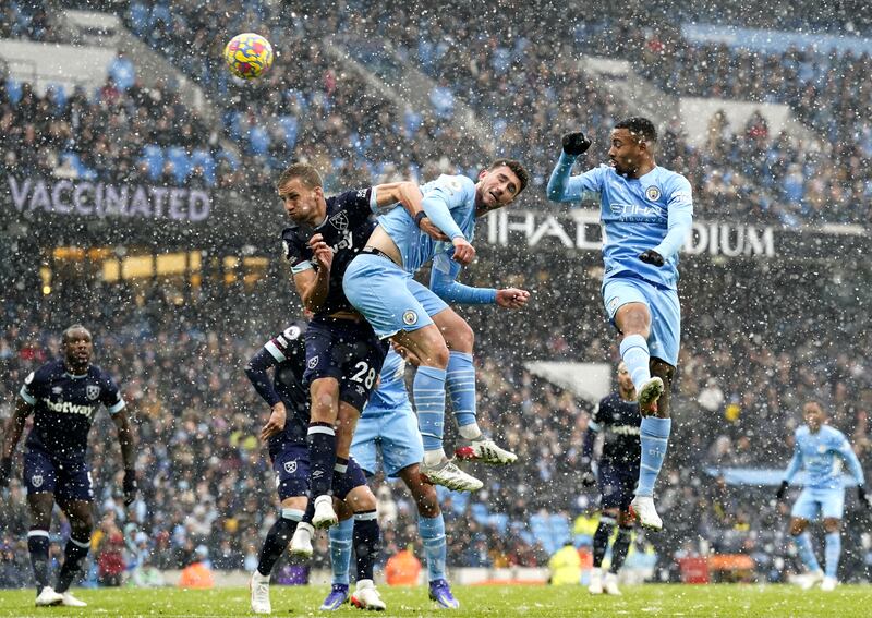 Aymeric Laporte and Tomas Soucek compete for a header. EPA