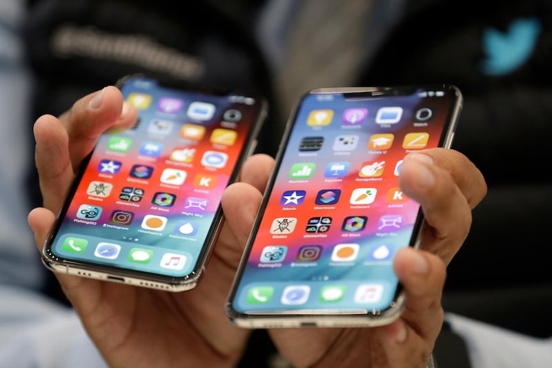 The iPhone XS, left, and XS Max are displayed side to side during an event to announce new products at Apple headquarters Wednesday, Sept. 12, 2018, in Cupertino, Calif. (AP Photo/Marcio Jose Sanchez)