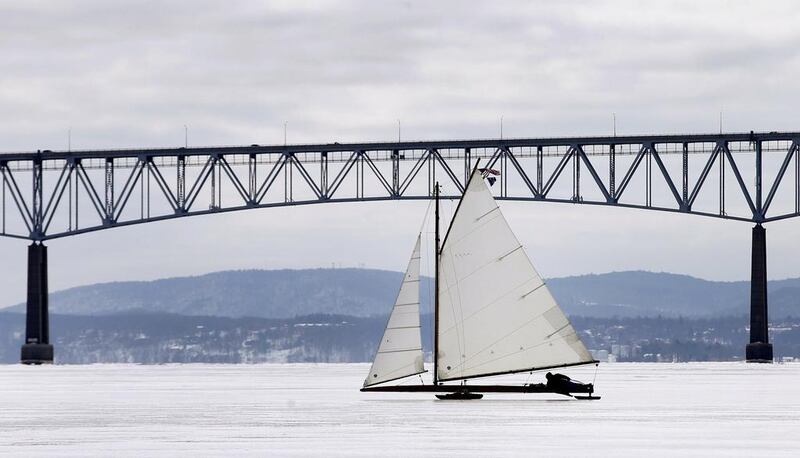 An antique ice sailboat from the Hudson River Ice Yacht Club sails on the frozen upper Hudson River beneath the Kingston-Rhinecliff Bridge near Astor Point in Barrytown, New York. (Mike Segar / Reuters / March 7, 2014)