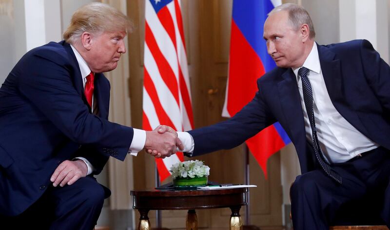 FILE- In this file photo taken on Monday, July 16, 2018, U.S. President Donald Trump, left, and Russian President Vladimir Putin, shake hands at the beginning of a meeting at the Presidential Palace in Helsinki, Finland.  The Kremlin said Wednesday Nov. 28, 2018, it still expects a meeting between President Vladimir Putin and President Donald Trump to go ahead as planned despite a suggestion from Trump that it could be canceled. (AP Photo/Pablo Martinez Monsivais, File)