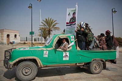 Armed Houthi fighters ride on a vehicle as they attend the funeral procession of Houthi rebel fighters who were killed in recent fighting with forces of Yemen's internationally recognized government in Sanaa, Yemen, Tuesday, Mar. 2, 2021. (AP Photo/Hani Mohammed)