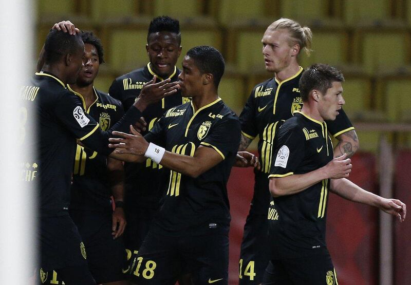 Lille players celebrate after Divock Origi, centre, scores the 1-1 equaliser on Sunday v Monaco. Valery Hache / AFP / March 23, 2014 