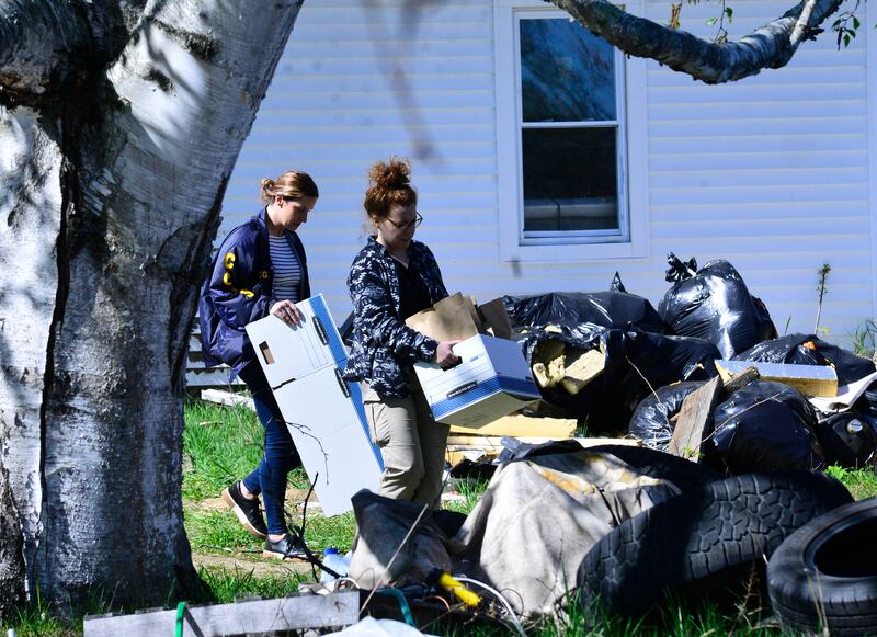 Evidence being removed from Mr Carman's house. The Brattleboro Reformer / AP