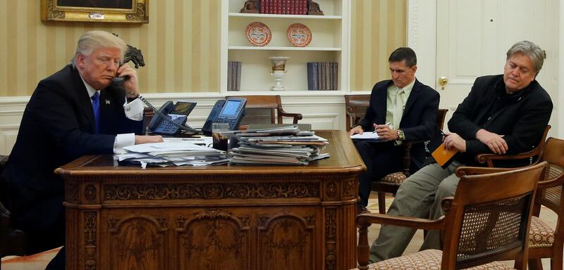 FILE PHOTO: U.S. President Donald Trump (L), seated at his desk with National Security Advisor Michael Flynn (2nd R) and senior advisor Steve Bannon (R), speaks by phone with Australia's Prime Minister Malcolm Turnbull in the Oval Office at the White House in Washington, U.S. January 28, 2017. REUTERS/Jonathan Ernst/File Photo