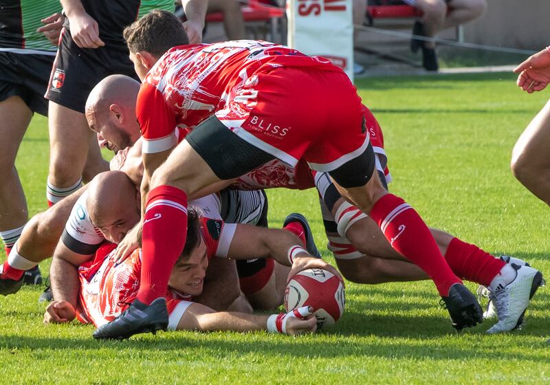 Charlie Taylor of Dubai Tigers hands off the ball.