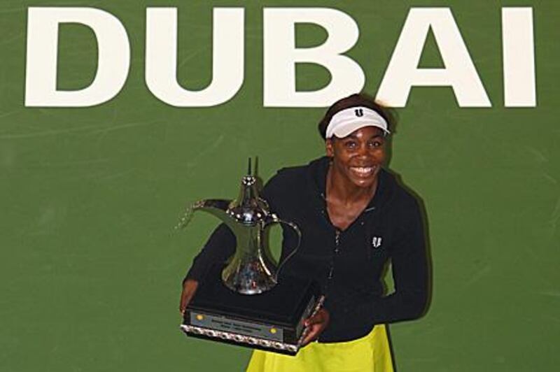 Venus Williams poses with the winner's trophy after defeating Victoria Azarenka of Belarus 6-3, 7-5 last night in the final of the WTA Dubai Tennis Championships.