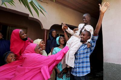 Muhammed Bello, a rescued student, is carried by his father as his relatives celebrate after he retuned home in Kankara, Nigeria, December 19, 2020. REUTERS/Afolabi Sotunde