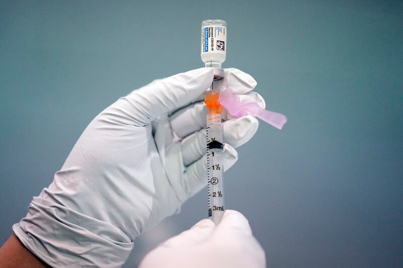 A member of the Philadelphia Fire Department prepares a dose of the Johnson & Johnson Covid-19 vaccine at a vaccination site setup in Philadelphia. AP