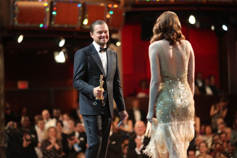 Leonardo DiCaprio presents Emma Stone with the Best Actress Oscar for La La Land at the 89th Academy Awards  on February 26, 2017. AFP
