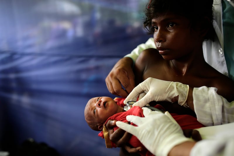 A doctor examines a 10-day-old Rohingya child in a medical centre in a camp in Ukhiya, Cox's Bazar, Bangladesh. Abir Abdullah / EPA