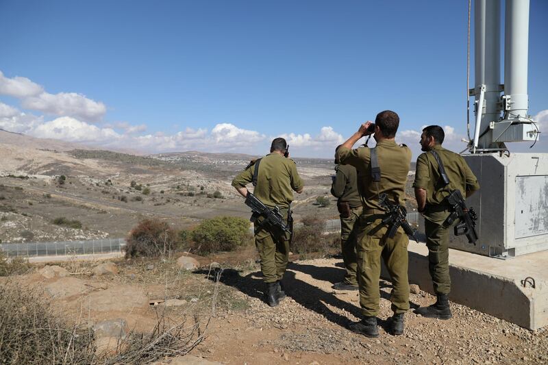 Israeli forces are seen near a border fence between the Israeli-occupied side of the Golan Heights and Syria, November 4, 2017. REUTERS/Ammar Awad
