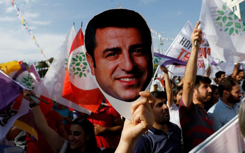 FILE PHOTO: A supporter of the pro-Kurdish Peoples' Democratic Party (HDP) holds a mask of their jailed former leader and presidential candidate Selahattin Demirtas during a rally in Ankara, Turkey, June 19, 2018. REUTERS/Umit Bektas/File Photo