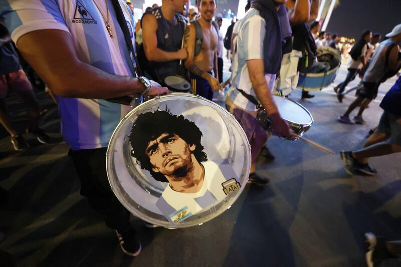 An Argentina fan bangs his drum showing an image of former player Diego Maradona. Reuters