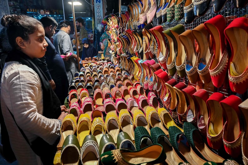 People check out footwear at a market in Islamabad. AFP