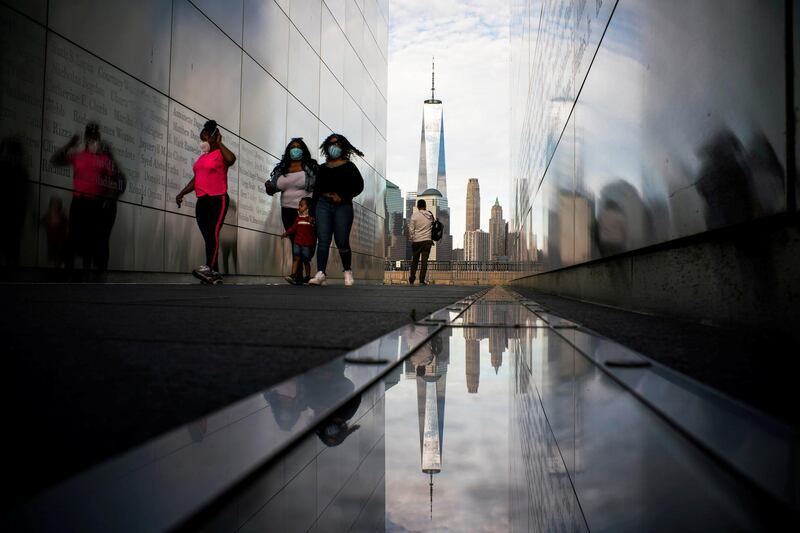 People visit the Empty Sky Memorial as the The One World Trade Center in New York is seen from Liberty State Park after many New Jersey Parks set to re-open during the outbreak of the coronavirus disease in Jersey City, New Jersey. Reuters