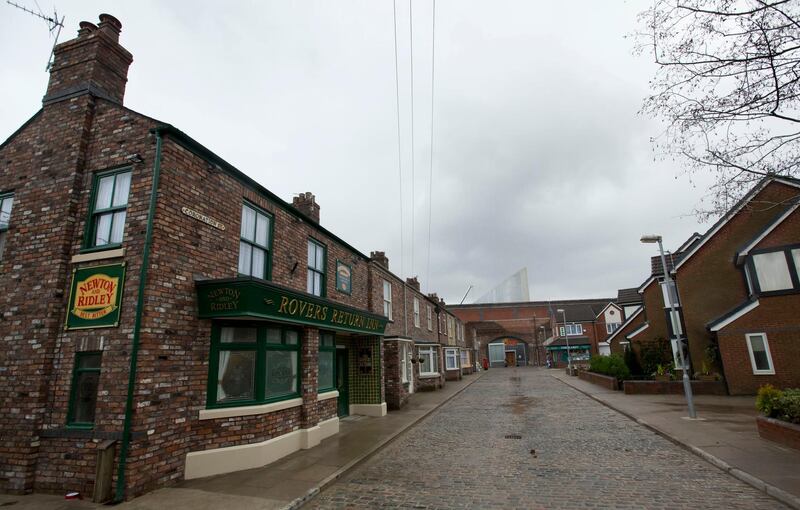FILE - In this file photo dated Friday, Nov. 29, 2013, the film set of long running British soap opera entitled 'Coronation Street', in Manchester, England. The long running TV series covering an intimate look into the lives of families in the fictional north England town, will introduce its first black family into the series, in its 59-year history, according to an announcement by Producer Iain MacLeod, Sunday April 7, 2019. (AP Photo/Jon Super, FILE)